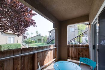 Corner Patio with sliding glass door to Living area - 4 foot fence - stucco walls and ceiling